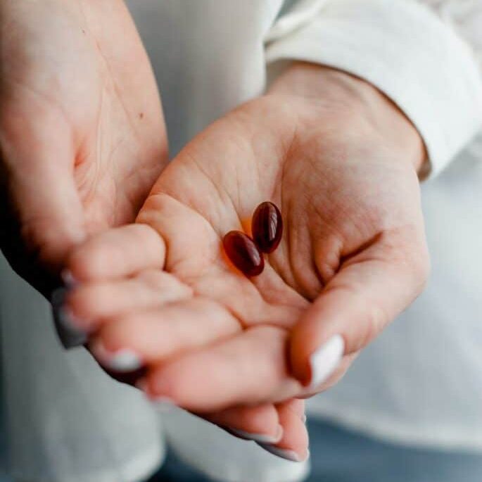 person holding brown and black round ornament